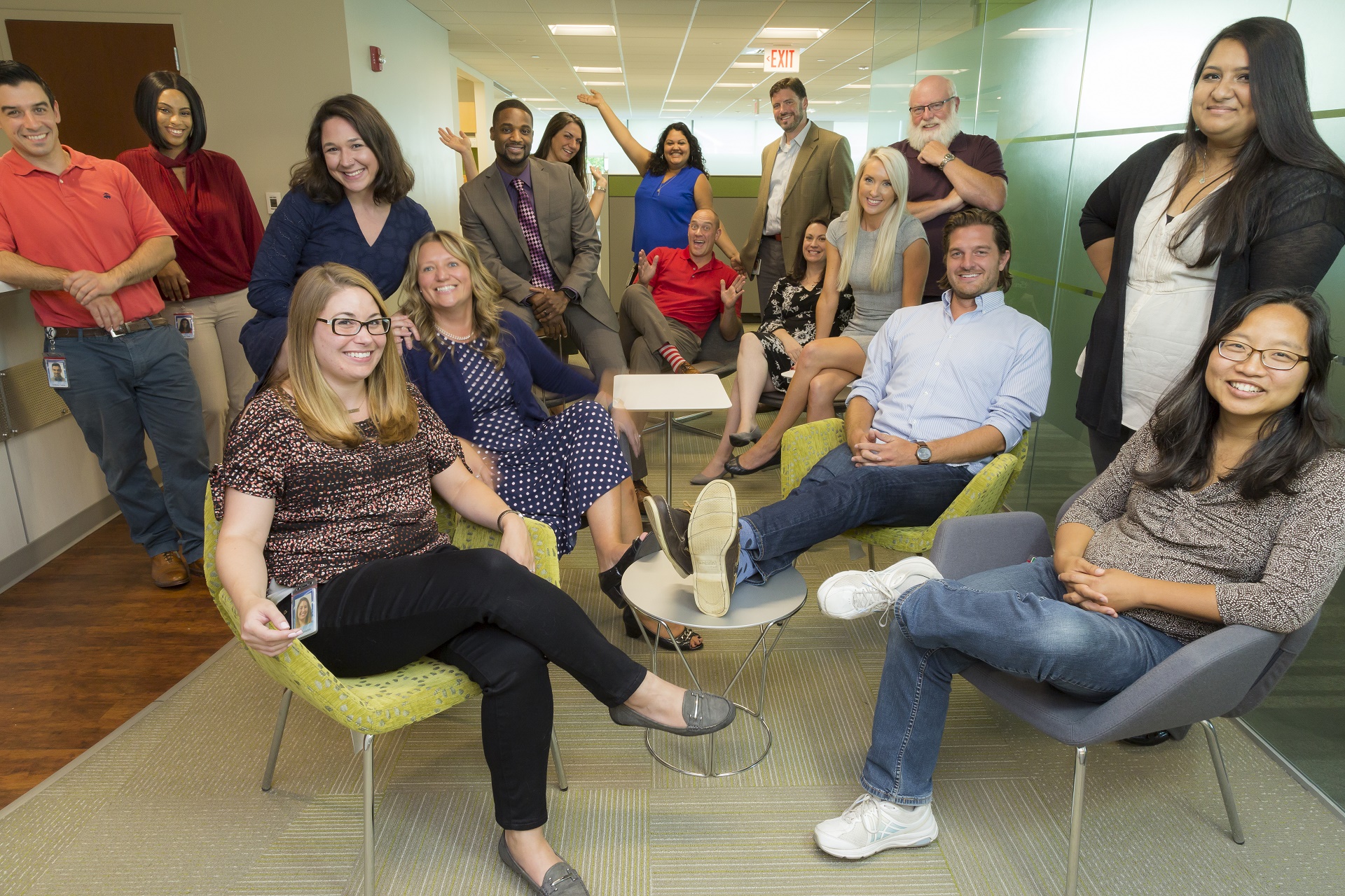 COCC employees gathered in a collaboration space smiling at the camera