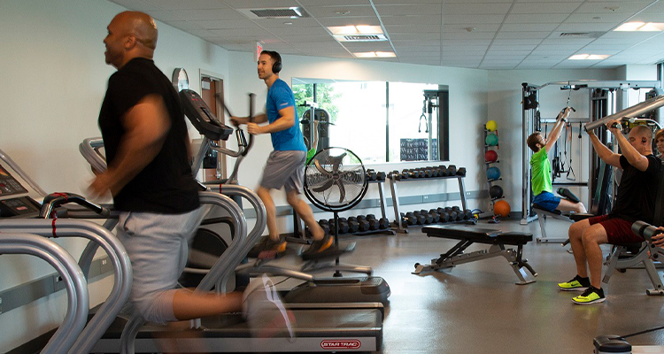 COCC employees work out in the treadmill and weight machines in Southington fitness center